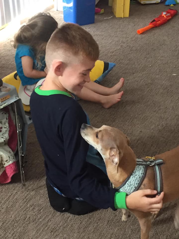 children playing with puppy