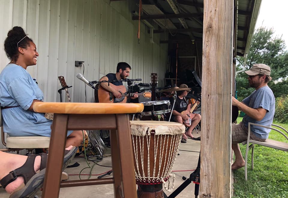 musicians playing outside a barn