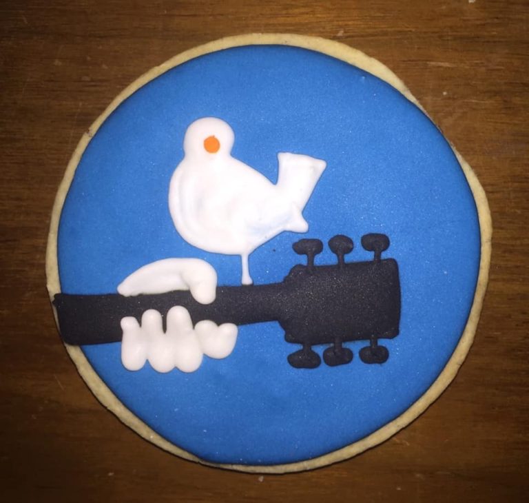 frosted cookie showing guitar neck and white bird
